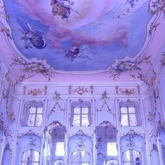 the ceiling is painted in blue and white with angels on it, as well as windows