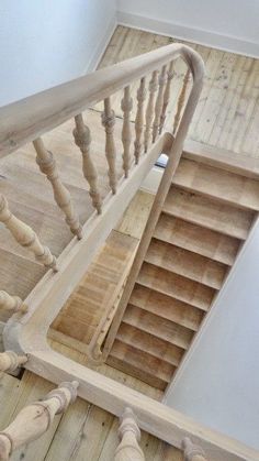 an overhead view of a wooden staircase with handrails