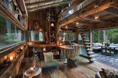 the inside of a cabin with wood floors and stairs