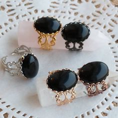 This black onyx filigree ring features black onyx stones (which measure 13 x 18 mm.)    Black Onyx is the semi-precious birthstone for July.  If you're into boho chic, or cottagecore, this onyx stone ring is a great accessory for you - and I have it in a variety of finishes.   It's easily adjustable by gently pulling the sides apart, or closer together. Like everything else here in HollysPrivateIdaho, they are made with love in a smoke-free home. Please allow 24 - 48 hours for creation and packa Elegant Black Oval Crystal Ring, Black Cabochon Jewelry For Wedding, Black Cabochon Wedding Jewelry, Elegant Adjustable Onyx Rings, Black Cabochon Victorian Jewelry, Victorian Black Cabochon Jewelry, Black Oval Filigree Ring For Formal Occasions, Black Victorian Rings With Black Enamel, Black Victorian Ring With Black Enamel