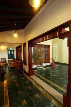 an empty room with green tile flooring and wood trimming on the walls,