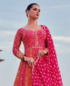 COLOR : Orange & Pink FABRIC : Gown & Dupatta - Premium Georgette WORK : Heavy Zari Work, Hand Work, Motifs, Stones, Pearls, Swarvoski, Sequins, Embellished Lace Border OCCASION : Wedding, Reception, Engagement, Bridal Wear READY-TO-WEAR : NoSTITCHING : Available as semi-stitched fabric, can be stitched using standard size option (+$30). Note: There might be a slight color variation due to lighting and flash used during photoshoot. The bright shade seen is the best closer view of fabric's color. Bridal Anarkali, Orange Suit, Anarkali Gown, Pink Bridal, Zari Work, Georgette Fabric, Lace Border, Hand Work, Pink Fabric