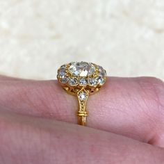 a close up of a person's hand with a gold ring on top of it