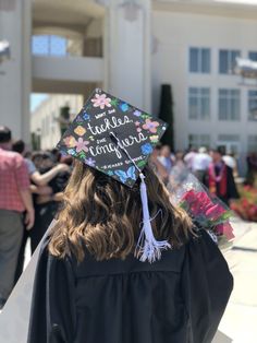 a graduation cap that says just married on it in front of a group of people