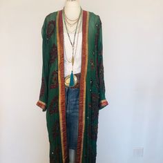 "A Beautiful Kimono Jacket,Robe . Long beaded,sequinned and floaty ; A Perfect Cover Up for Holidays , Weddings and Parties.  This has been Handmade from a Vintage Indian Sari.... so is completely Unique and Sustainable. A Wonderfully Chic,Forest Green Silk Chiffon,Embellished all over with contrasting Ruby red , black and bronze paisley embroidery ; 1000's of Glittering Silver bugle beads and Diamantes, and a Gold Brocade border . One Size S M L   UK size 8 to 16     US 6 to 12      European 36 to 44, The length is 133 cm / 52.5 \". The sleeves are 52 cm / 20.5 \". This Beautiful unique jacket will soon become your Favourite Go To in your wardrobe . Timeless Boho Chic ! To see more unique designs like this please visit my Etsy Boutique at: https://www.etsy.com/shop/BohoStarIbiza" Long Floral Embroidered Kimono For Festival, Long Floral Embroidery Kimono For Festivals, Fitted Bohemian Kimono For Festivals, Bohemian Kimono With Intricate Embroidery, Bohemian Long Sleeve Kimono With Intricate Embroidery, Bohemian Long Kimono With Intricate Embroidery, Long Sleeve Bohemian Kimono With Intricate Embroidery, Festive Bohemian Embroidered Kimono, Bohemian Long Kimono With Multicolor Embroidery