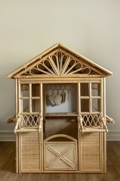 a doll house made out of bamboo and wicker