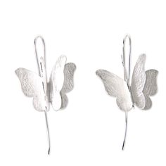 Double sets of wings give these butterflies the illusion of motion in these drop earrings. The ethereal earrings are crafted by Desi Antari of sterling silver with a brushed finish that gives them a contemporary vibe. The butterflies are poised on polished silver hooks. Sterling silver Hook earrings Brushed-satin finish Handmade in & fairly traded from Indonesia Butterfly Wing Jewelry, Silver Butterfly Earrings, Paw Print Jewelry, Wing Jewelry, Ribbon Jewelry, Sterling Silver Drop Earrings, Printed Jewelry, Butterfly Wing, Butterfly Jewelry