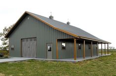 a large metal building with two garages on the front and one door open to let in light