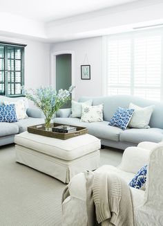 a living room with blue and white furniture