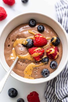 a bowl filled with chocolate pudding and berries