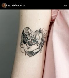 a woman's arm with a tattoo on it that has an anime character in the shape of a heart