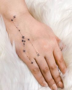 a woman's hand with stars on it and the word star written in black ink