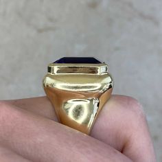 An impressive vintage cocktail ring featuring an emerald-cut amethyst center weighing approximately 15 carats. The amethyst is bezel-set in 18k yellow gold. This ring was handcrafted in 18k yellow gold, circa 1980.
The overall measurements of the amethyst including the bezel are approximately 19.64mm x 18.05mm.
The current size of this ring is 7.25 and can be resized at no extra cost.
Ready to Make It Yours? Reserve it now or get more info! Formal Gold Amethyst Ring With Bezel Setting, Luxury Emerald-cut Amethyst Ring For Formal Events, Luxury Emerald Cut Amethyst Ring For Formal Occasions, Timeless Gold Amethyst Ring, Luxury Gold Amethyst Ring With Bezel Setting, Luxury Gold Emerald Cut Amethyst Ring, Luxury Yellow Gold Amethyst Ring With Emerald Cut, Gold Rectangular Amethyst Ring For Formal Occasions, Classic Amethyst Signet Ring With Polished Finish