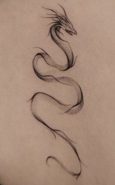 the back of a woman's neck with a tattoo design on it, and a snake