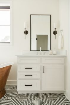 a bath room with a tub and a mirror