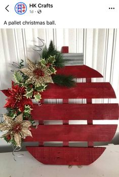 a wooden christmas ornament with poinsettis and greenery on it