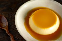 an egg yolk in a bowl with a wooden spoon