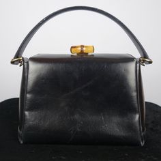 Vintage Gucci Black Leather Bamboo Turnlock Top Handle Bag With Crossbody Strap Made In Italy. * Tracking Number Included * Sourced From The Reuse Sector. Size - Small Suggestions - Collector's Item - Casual & Formal Item Condition Please Understand That Since These Items Are Vintage And/Or Recycled, They May In Fact Show A Little Sign Of Wear, Aging, Or Slight Discoloration. If We List Something As New Old Stock (Nos) Or New, It Will Be In Excellent Condition. Any Other Characterization Is Subj Gucci Evening Bags With Top Handle, Gucci Rectangular Satchel For Evening, Rectangular Gucci Satchel For Evening, Gucci Rectangular Evening Satchel, Gucci Satchel With Gold-tone Hardware For Evening, Gucci Satchel With Detachable Strap For Formal Occasions, Formal Gucci Satchel With Detachable Strap, Gucci Formal Satchel Bag, Gucci Top Handle Evening Satchel