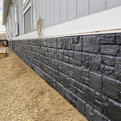 a brick wall next to a white building