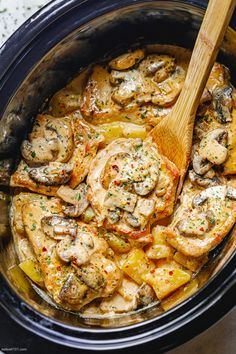 a slow cooker filled with chicken and mushrooms