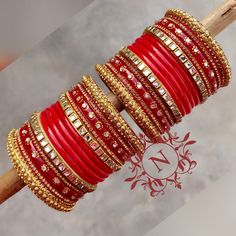 Red Sets For Wedding And Festivals, Red Wedding Sets For Festivals, Festive Bridal Sets For Parties, Bollywood Embroidered Festive Jewelry, Red Kundan Bangle With Zari Work, Red Stone Work Sets For Diwali, Red Sets With Stone Work For Diwali, Red Traditional Wear For Marriage, Elegant Red Bangle For Wedding