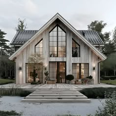 a large white house with lots of windows and steps leading up to the front door