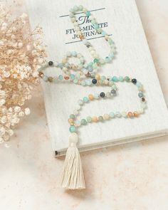 This Mala Beads Necklace is hand-knotted with Amazonite crystals and features 14K Gold-filled accent beads and a handmade cotton tassel. • Hand-knotted traditional style • This piece has the traditional 108 beads Spiritual Tassel Necklace With 108 Round Beads, Spiritual Beaded Tassel Necklace For Beach, Adjustable Spiritual Tassel Necklace With Natural Stones, Bohemian Adjustable Hand-strung Mala, Bohemian Hand-strung Adjustable Mala, Adjustable Hand-strung Bohemian Mala, Bohemian Hand Knotted Mala For Meditation, Spiritual Tassel Necklace With 108 Beads For Beach, Bohemian Hand Knotted Beads As Gift