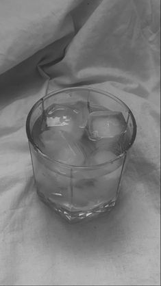 ice cubes in a glass bowl on a white cloth