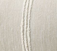 close up view of white fabric with stitching on the bottom and side of it