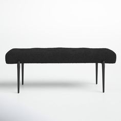 a black bench sitting on top of a white floor