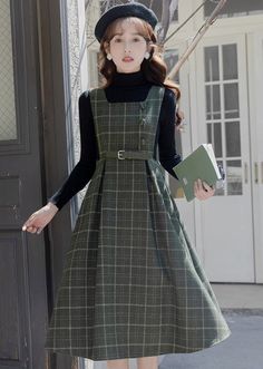 Our signature tweed plaid fabric in a classic pinafore silhouette. Features a square neckline, open sides, buttons, belted waist and midi length skirt. Lined. Concealed side zipper. S: 24.5" waist, 42" lengthM: 26" waist, 42" lengthL: 27.5" waist, 42.5" lengthXL: 29" waist, 42.5" length Winter Plaid Tweed Dress, Square Neck Winter Workwear Dress, Winter Workwear Dress With Square Neck, Wool Pinafore, Academic Chic, Dark Academia Wardrobe, Pinafore Outfit, Dark Academia Dress, Academia Dress