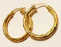 Fancy style, swirly hoop earrings:metal        : solid 14k yellow goldcast           : hollowweight      = 2.3 grdiameter  = 1.25"inch (30mm)thick          = 3 mmclosure      : snap downmade         : in Italy Elegant Twisted Hoop Earrings Gift, Elegant Spiral Hoop Earrings As Gift, Elegant Spiral Hoop Earrings For Gift, Spiral Yellow Gold Hoop Earrings As Gift, Elegant Cadmium-free Hoop Earrings As Gift, Elegant Hypoallergenic Hoop Earrings As Gift, Modern Twist Yellow Gold Hoop Earrings As Gift, Elegant Spiral Hypoallergenic Hoop Earrings, Spiral Yellow Gold Hoop Earrings For Gift