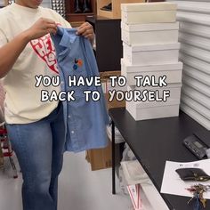 a woman holding up a shirt with the words you have to talk back to yourself