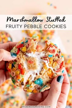 a person holding up a cookie with sprinkles on it and the words marshmallow stuffed fruit pebble cookies