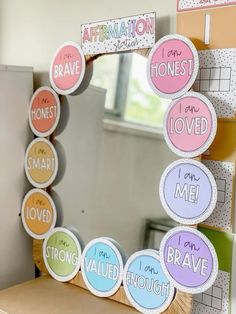 a mirror that has some stickers on it with words in different colors and shapes