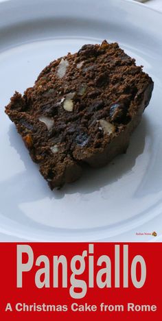 a white plate topped with a piece of cake on top of a red and white sign