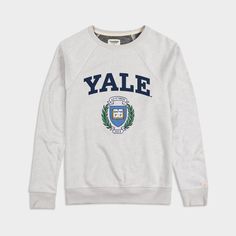 a white sweater with the word yale on it and an emblem in blue letters