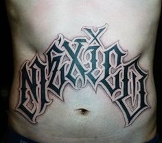 a man's stomach with the word tattoo on it