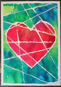 a red heart painted on top of a green and blue paper with white lines around it