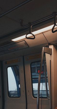 the inside of a subway car with its doors open and some windows showing in it