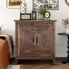 a wooden cabinet sitting in the corner of a living room