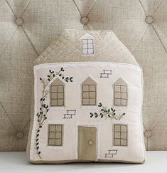 a decorative pillow with a house on it