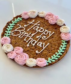 a birthday cake with frosting and flowers on it