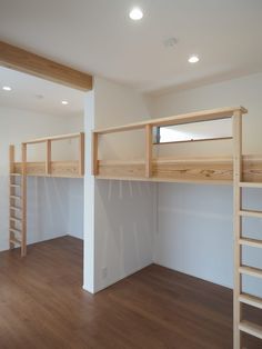 there is a loft bed in the middle of this room with two ladders on each side