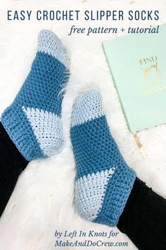 a pair of blue and white crocheted slippers sitting on top of a fur rug