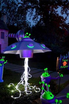 an illuminated garden with plants and lights in the shape of umbrellas on display at night