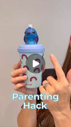 a woman holding up a sippy cup with an elephant on it and the words, parenting hack