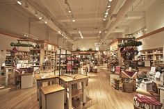 the inside of a store filled with lots of furniture and decor on wooden flooring