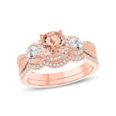 a rose gold ring set with an oval morganite and diamond accents on the band