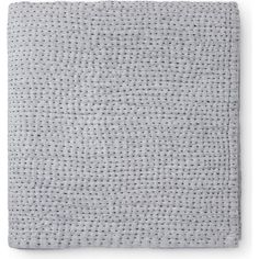 a white blanket with grey dots on it